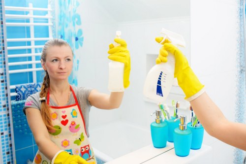 Cleaner working safely in a home environment with protective equipment