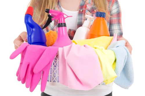 Cleaning staff following safe chemical handling procedures