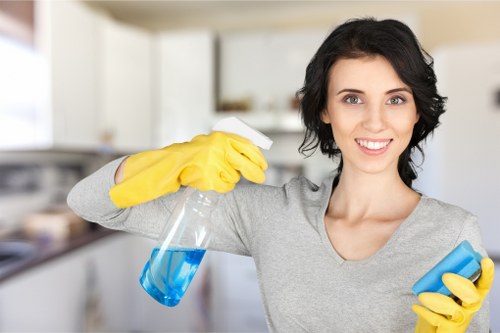Domestic cleaner in Hammersmith tidying a stylish flat interior
