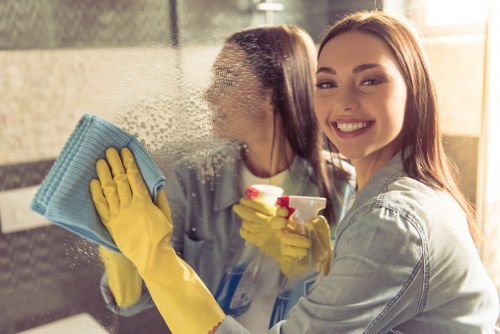 Cleaner using safe lifting techniques during routine work